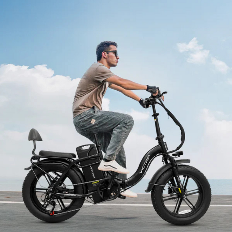 Man riding Victrip Titan S along the sea on path wearing sunglasses