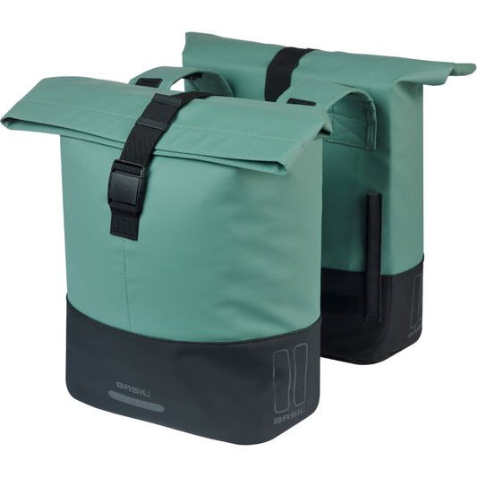 Two silvergreen/black Basil Cove bike panniers with black straps on a white background