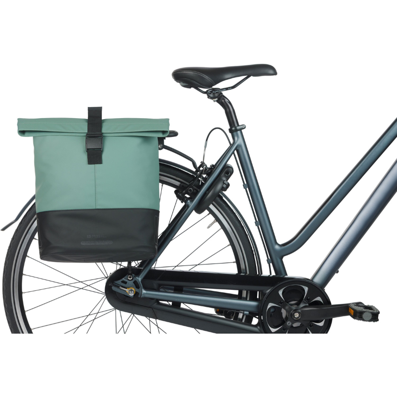 Bicycle with a green bag attached to the back right side profile on a white background