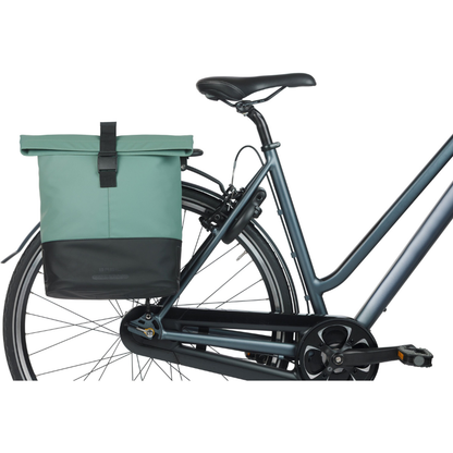 Bicycle with a green bag attached to the back right side profile on a white background
