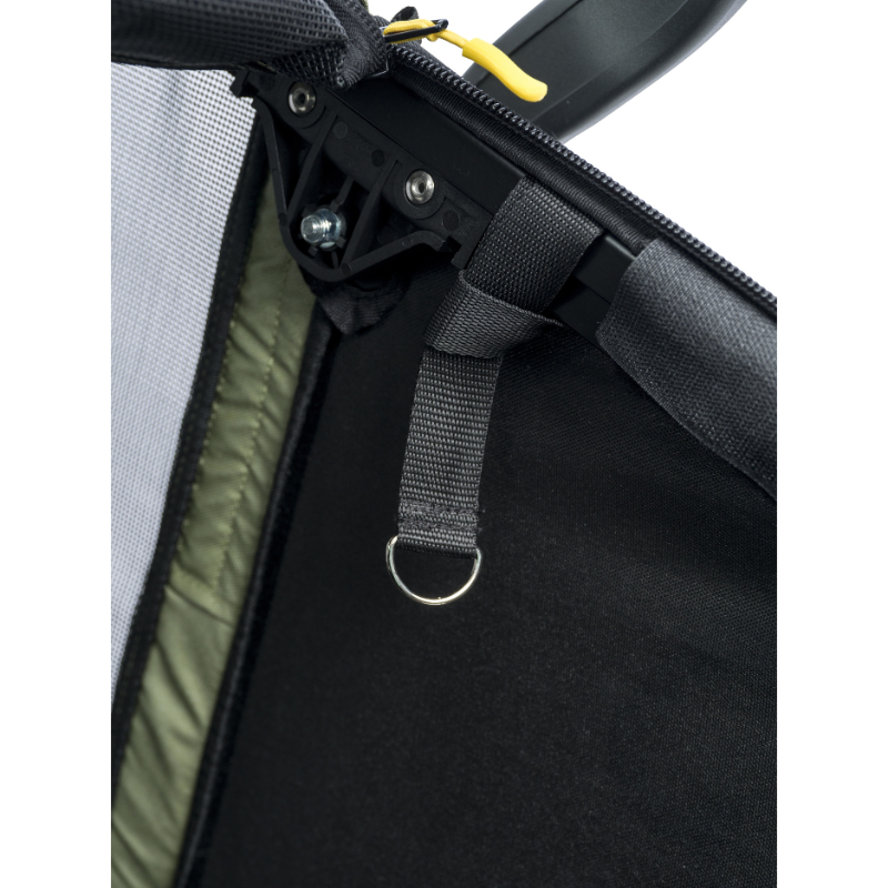 Close-up detail of a black mesh and fabric pet carrier or bag, showing a black zipper track, black webbing strap with a metal D-ring, olive green interior lining, and a small yellow zipper pull on a white background.