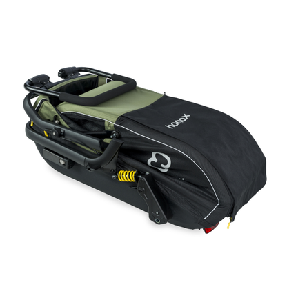 A black and olive green hamax stroller folded,  on a clean white background.
