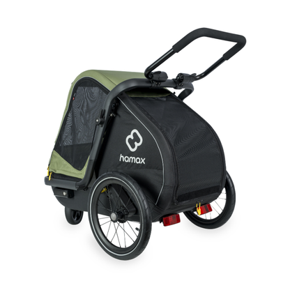 Hamax stroller trailer in black and olive green, featuring a black mesh body, black frame, and handlebar, with the Hamax logo on the side, shown on a white background.