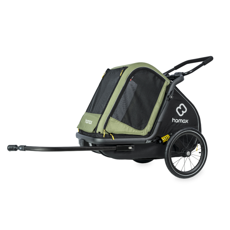 A Hamax pet trailer with a black frame and olive green mesh panels, shown from a side profile view with its front hitch extended on a white background.